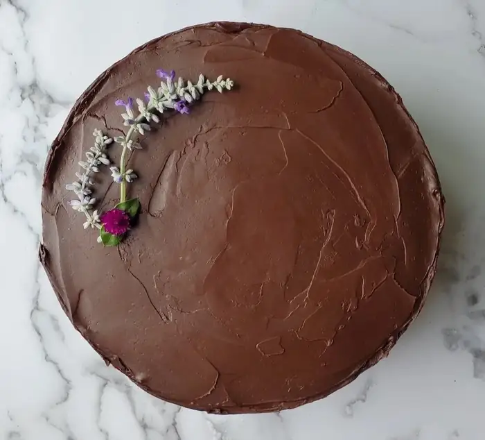 Chocolate cake with chocolate ganache and fresh flowers