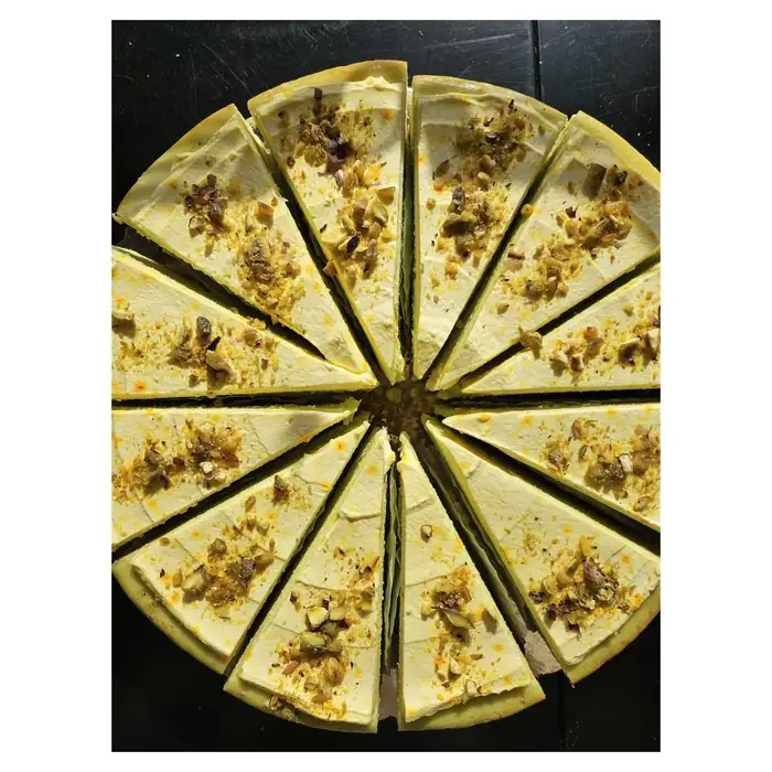 Akbar — Mashti pistachio-saffron cheesecake, sliced