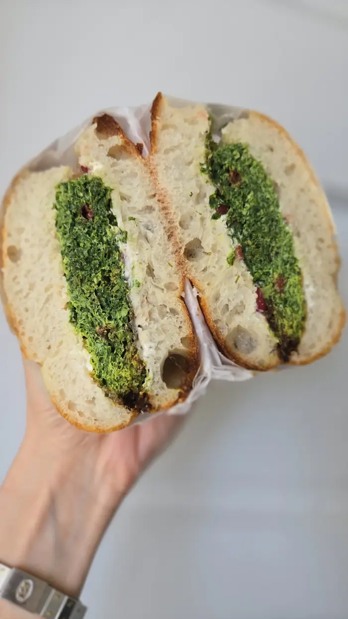 Kuku Sabzi herb sandwich with whipped olive yogurt on focaccia